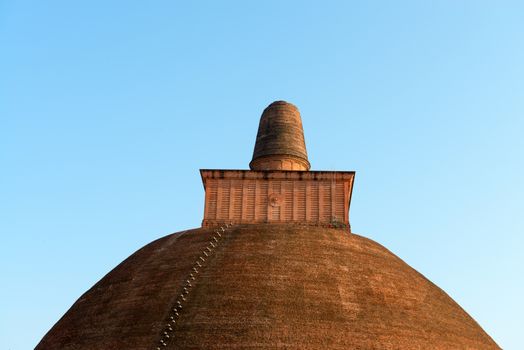 Top of Jetavaranama dagoba (stupa) with blue sky on background. Anuradhapura, Sri Lanka 