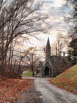 country road in autumn leading to a church