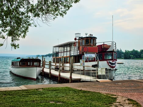 two vintage boats docked in summertime