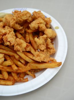 fried conch fritters and fries on a plate