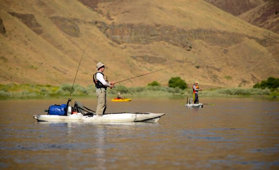 Fishing and Kayaking in a kayak on John Day River in Central Oregon