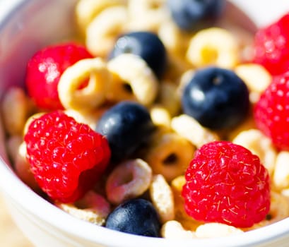 Healthy breakfast with cereals, blueberry, raspberry. Selective focus.