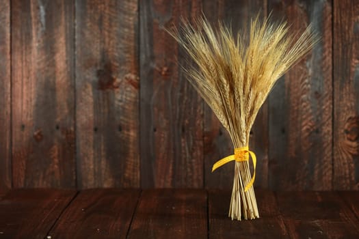 Whispy Wheat Grain Stalks on Grunge Wooden Background