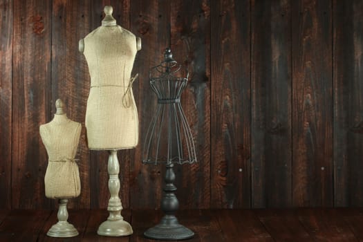 Vintage Antique Mannequin Busts on Wood Grunge Background
