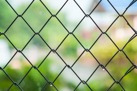 Steel cage with blur background in raining day