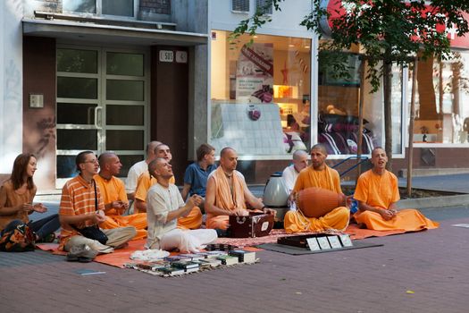 BRATISLAVA, SLOVAKIA - JULY 22: Members of Hare Krishna sit and sing on one of the central streets of Bratislava, Slovakia July 22, 2013