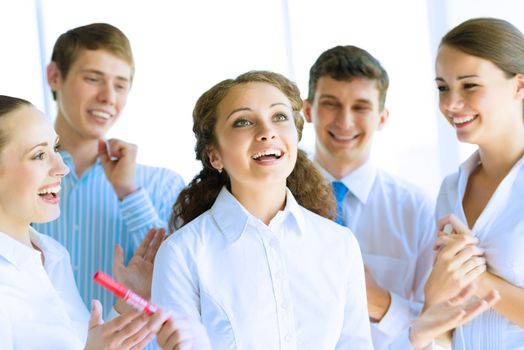 Successful business woman receiving congratulations from his colleagues, business success