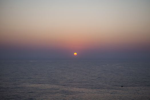 The sun rises over the calm waters of the Mediterranean Sea in Malta