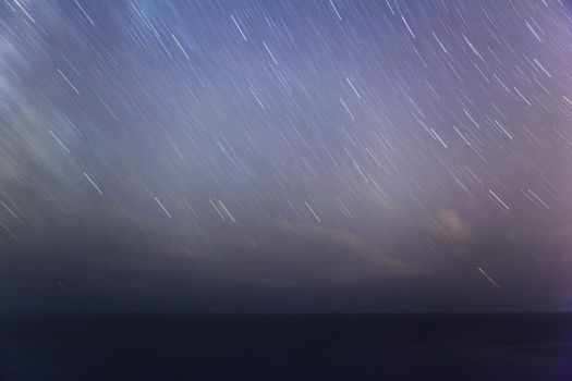 Extreme long exposure image showing star trails above the Mediterranean Sea