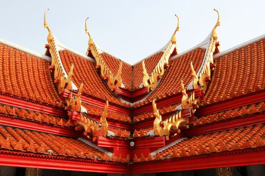 Multi layered roof with the figure of deity holding two palms to perform veneration's glazed tile