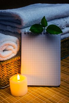 Spa with towels with a candle and pad