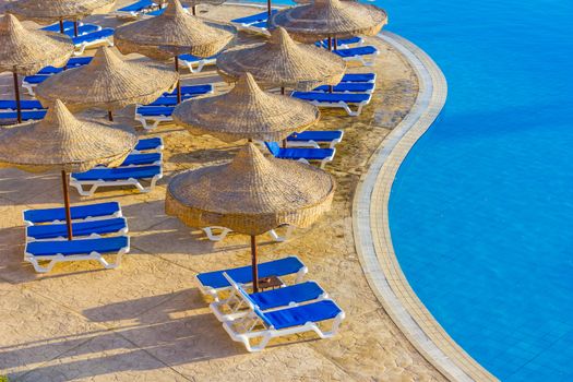 The view from the window of the hotel in Egypt to the pool, sun umbrellas and the Red Sea