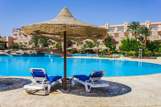 The view from the window of the hotel in Egypt to the pool, sun umbrellas and the Red Sea