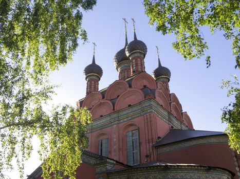 Russian Church in surrounding of green birch leaves by summer. The Church of the Epiphany is one of the famous architectural and painting monuments of the 17th century in Yaroslavl 