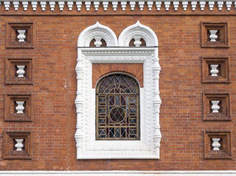 Russian church brick wall with window and traditional decoration in Yaroslavl