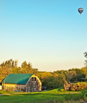 barn with hot air balloon on an autumn morning