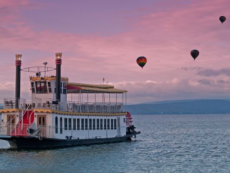 steamboat and hot air balloons evening scene