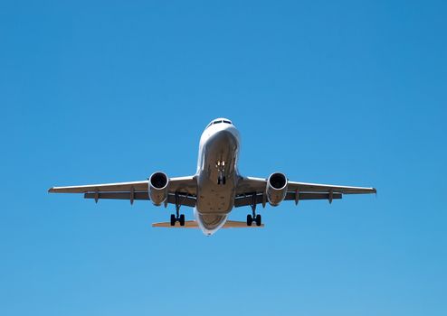 airplane landing on clear sunny day