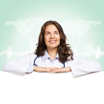 Young attractive female doctor put her hands on the blank banner, place for text