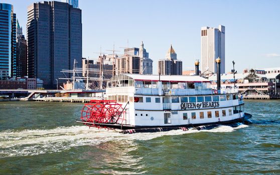 NEW YORK CITY, USA - SEPTEMBER 21 : Paddle Wheel Queen of Hearts steamboat is floating with tourists around Manhattan. It is very hot attraction for NYC visitors. Taken 21.9.2012 from the Brooklyn side.