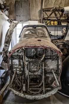 Cockpit section from an old aircraft lying in a workshop