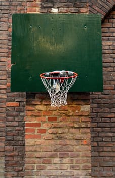 Grungy, Damaged Urban Basketball Net Against Brick Wall