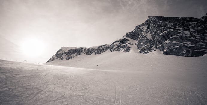 winter with ski slopes of kaprun resort next to kitzsteinhorn peak in austrian alps