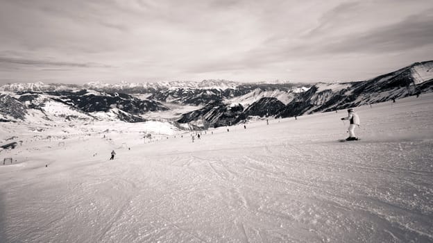 winter with ski slopes of kaprun resort next to kitzsteinhorn peak in austrian alps