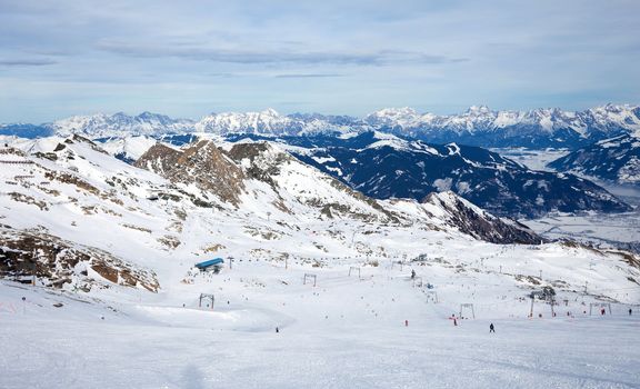 winter with ski slopes of kaprun resort next to kitzsteinhorn peak in austrian alps