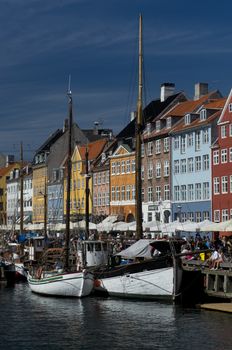 the skyline of the nyhavn, historical channel in the center of Copenhagen, Denmark, full of ancient multicolored houses