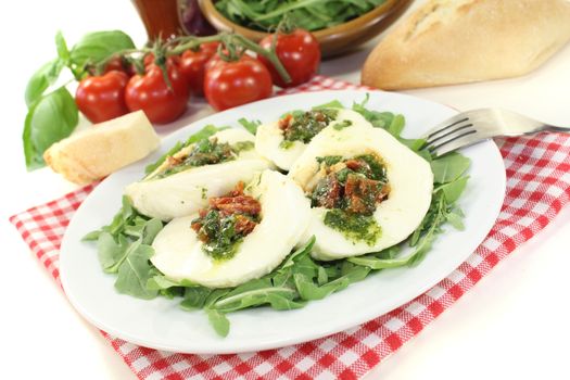 stuffed mozzarella with dried tomatoes on a light background