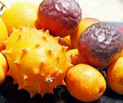 Exotic fruits: orange, kiwano, loquat, peach and passionfruit
