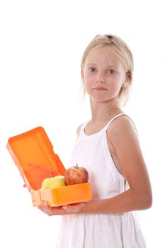 young girl opens lunchbox containing apples in studio against white background