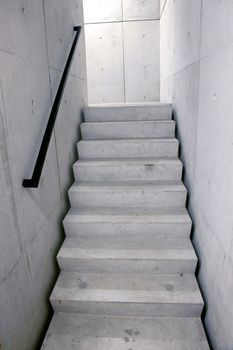 concrete staircase of parking garage and stairs leading upwards