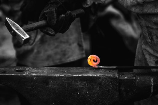 Detail shot of metal being worked at a blacksmith forge