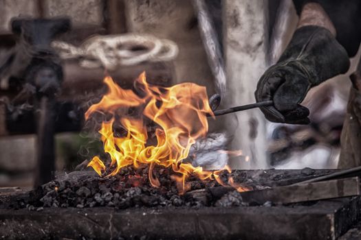 Detail shot of metal being worked at a blacksmith forge