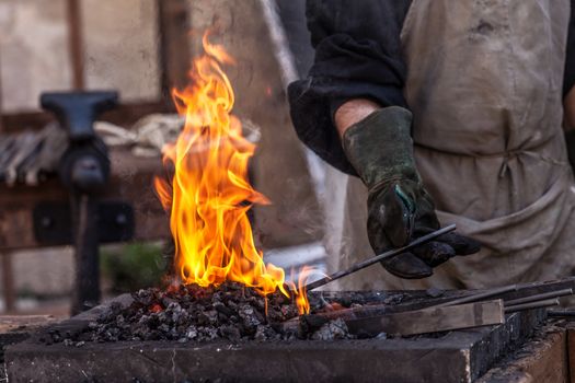 Detail shot of metal being worked at a blacksmith forge