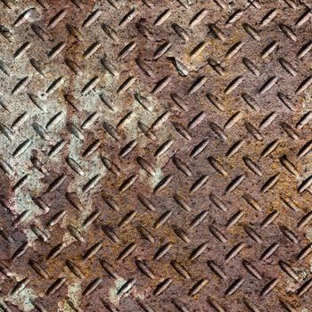 Background of old metal diamond plate in brown color.