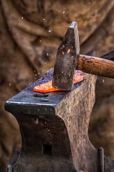 Detail shot of metal being worked at a blacksmith forge