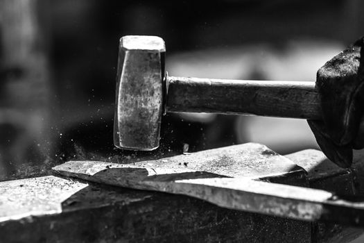 Detail shot of metal being worked at a blacksmith forge