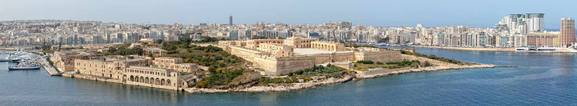 A panoramic view of Manoel Island, and the recently restored Fort carrying the same name.  On the left is the old Lazzaret Hospital and RN submarine depot; to the right the modern skyline of Sliema.
