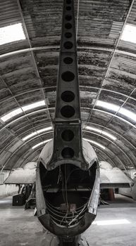 Tail section of an old aircraft lying in a hangar