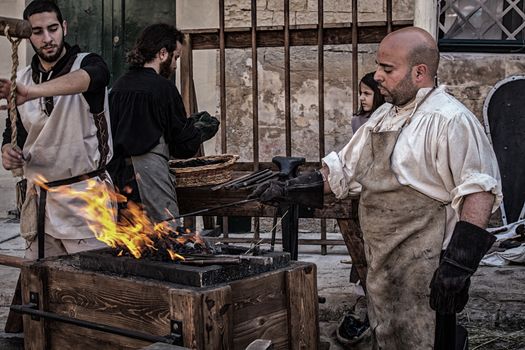 MDINA, MALTA - APR 13 - A medieval blacksmith during the Medieval Mdina festival in Mdina on 13 April 2013