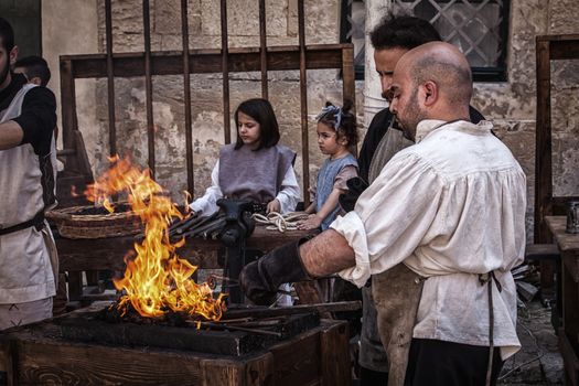 MDINA, MALTA - APR 13 - A medieval blacksmith during the Medieval Mdina festival in Mdina on 13 April 2013