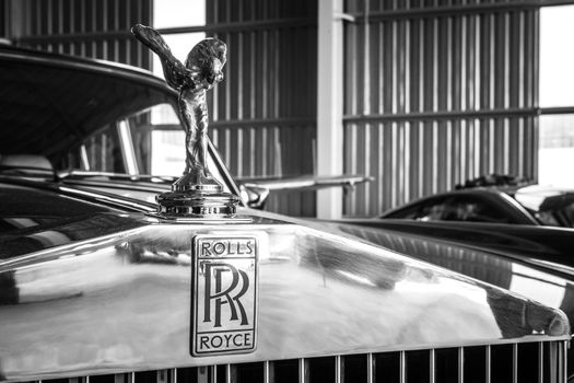 Detail monochrome shot of Rolls Royce grille and emblem.