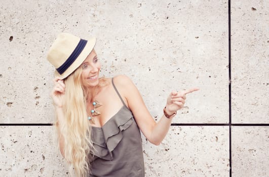 happy young blonde woman with hat outdoor summertime fashion beauty
