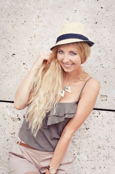 happy young blonde woman with hat outdoor summertime fashion beauty