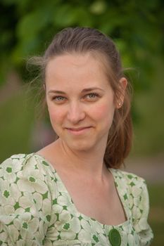 Beautiful young woman in park in summer