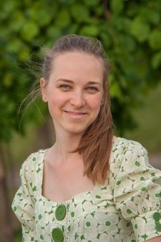 Beautiful young woman in park in summer