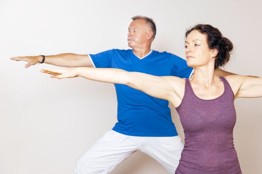 An image of some people doing yoga exercises